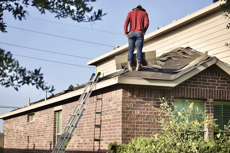 Professional roofer working on a residential roof in Brimfield Crossing